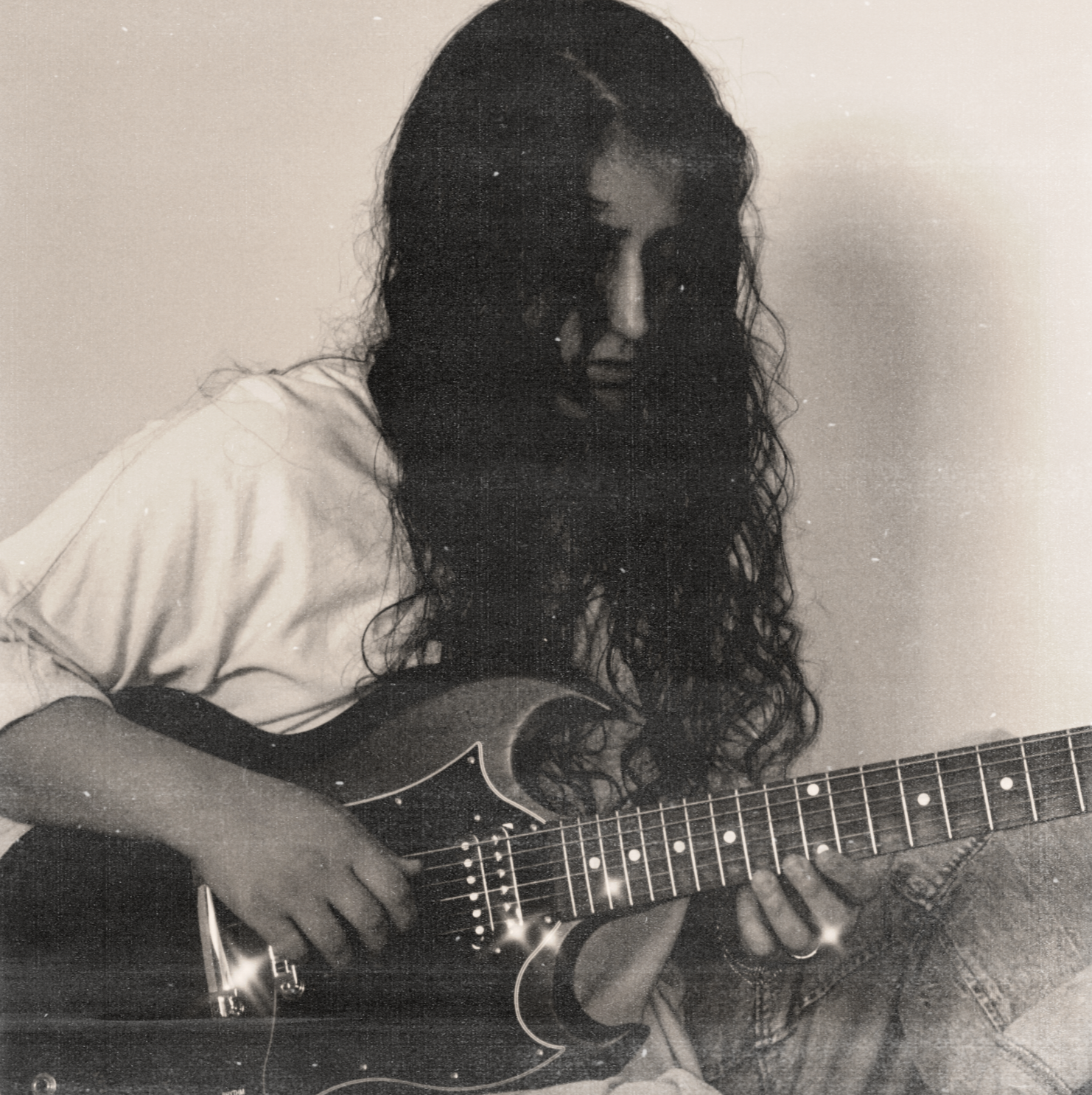 ANLIL posed on the ground wearing outfit from Urban Outfitters, holding her Gibson SG Electric Guitar