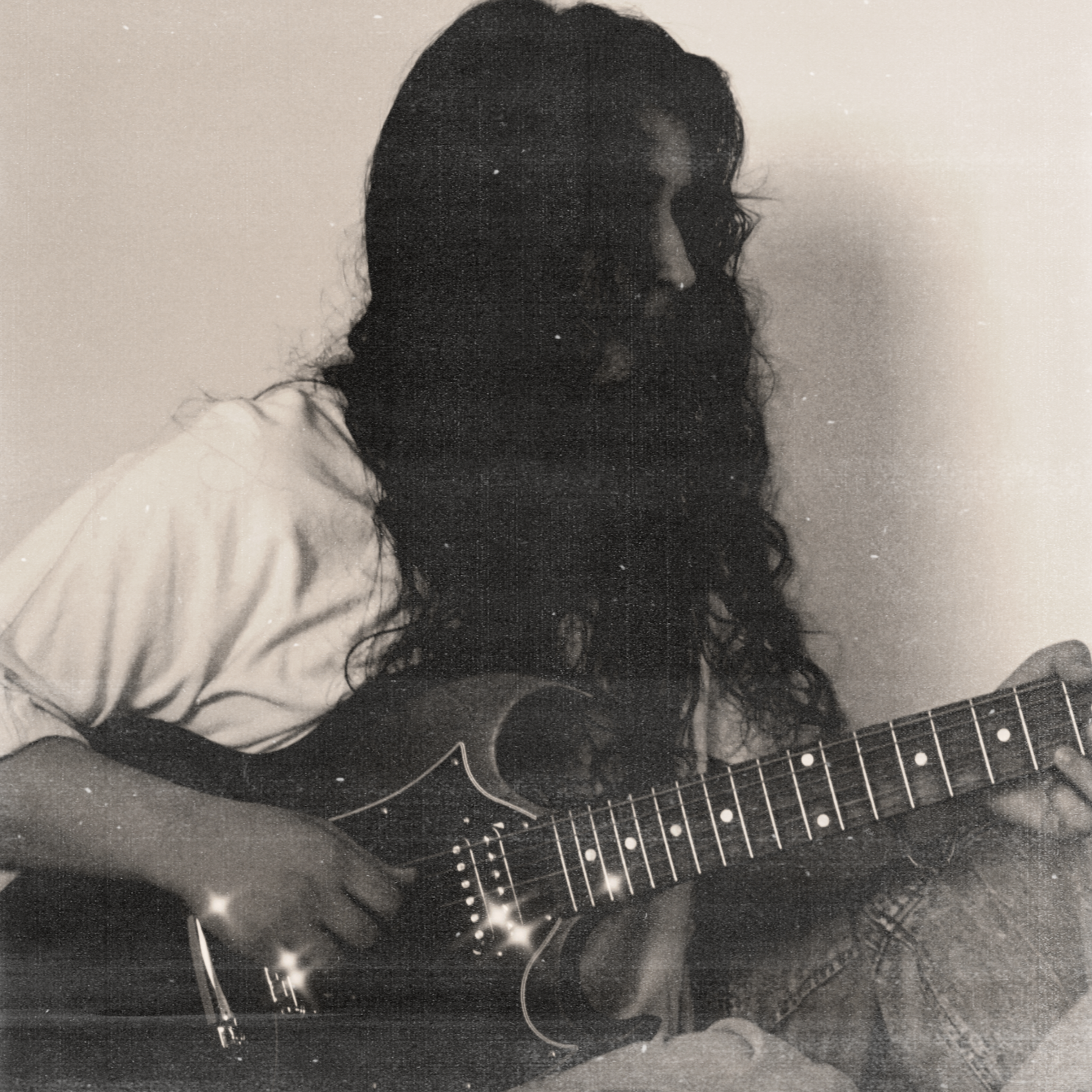 ANLIL posed on the ground wearing outfit from Urban Outfitters, holding her Gibson SG Electric Guitar