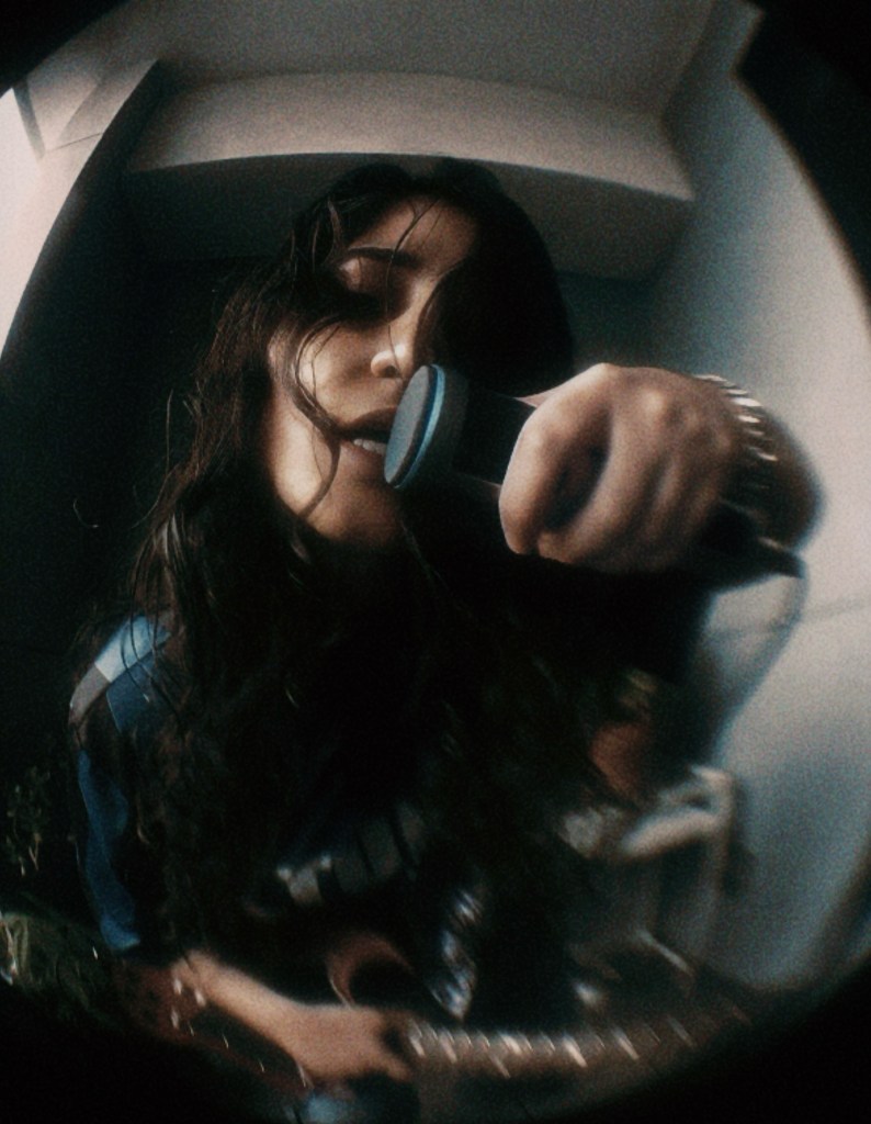 Moody black-and-white image of ANLIL with soft shadows falling across her face, reflecting introspection and emotional complexity.